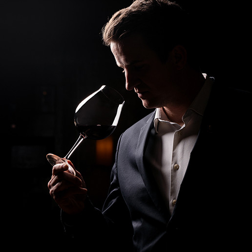 Man enjoying a glass of wine at Dans le Noir ?