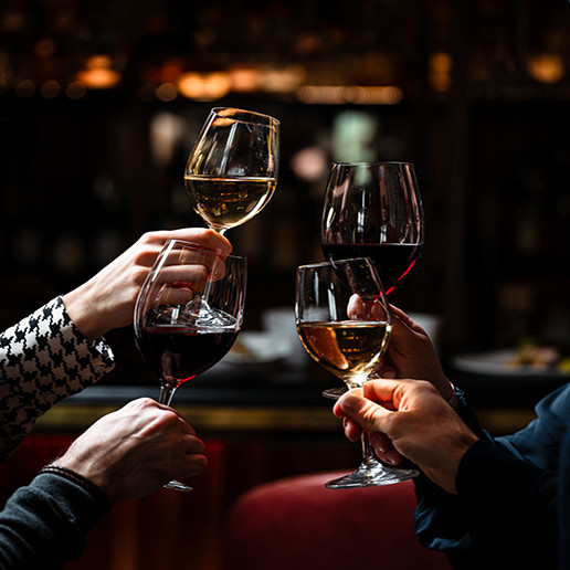 Colleagues raising glasses at Dans le Noir ? for a farewell party